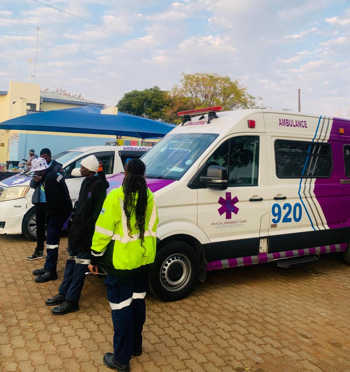 Crew beside a VW Crafter ambulance at an event